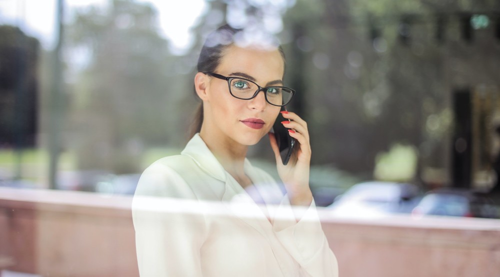Young businesswoman on her mobile phone buying a 1800 number