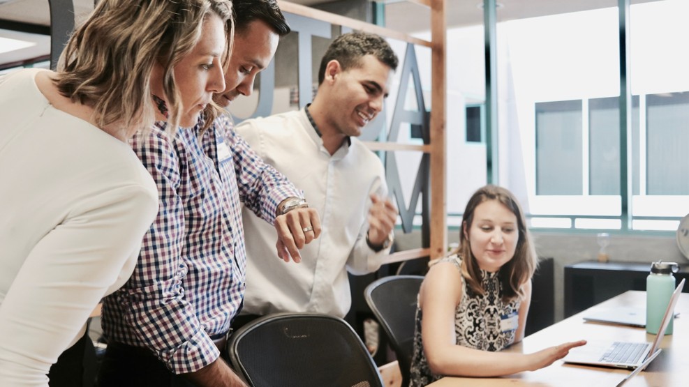 Young businesspeople in an office researching a 1300 Smartnumber